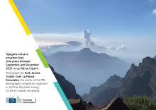 postcard from la palma with a volcanic erruption in the background and mountains in the foreground