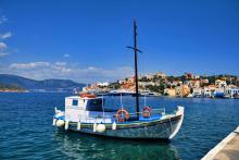 Boat in harbour, houses in the background
