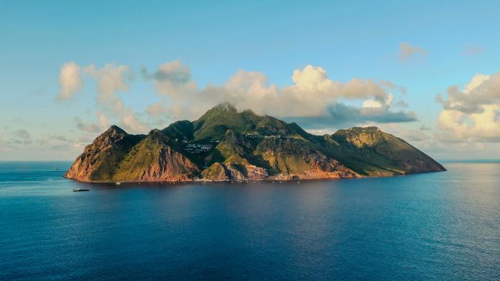 Aerial view from far away where the whole island of Saba is visible