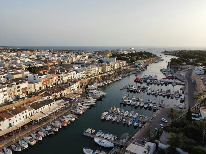 harbour in bay full of sail boats and lined with houses